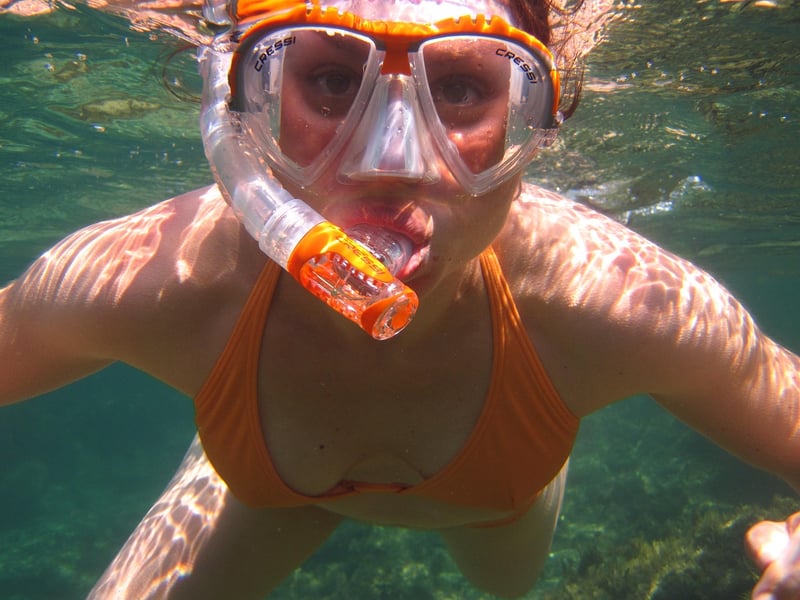 Person snorkeling in clear water